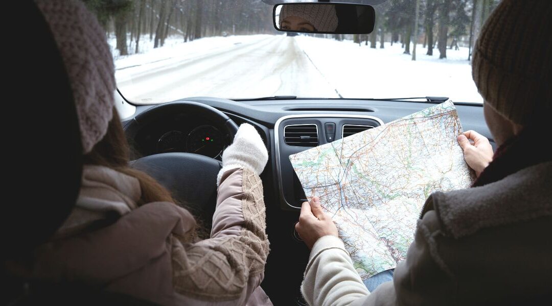 Holiday travel tips, a couple driving in the icy winter road